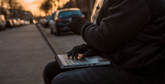 Une personne qui pirate une voiture via son ordinateur